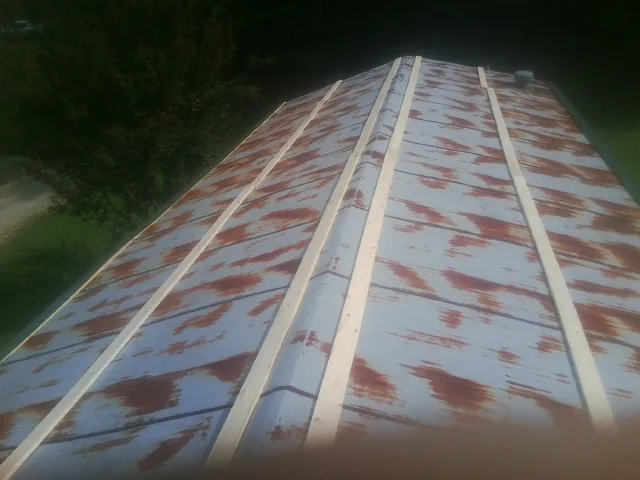 Rusted metal roof panels with new wood purlins before replacement — Storm Damage Roof Repair in Maywood by Roofing Brothers